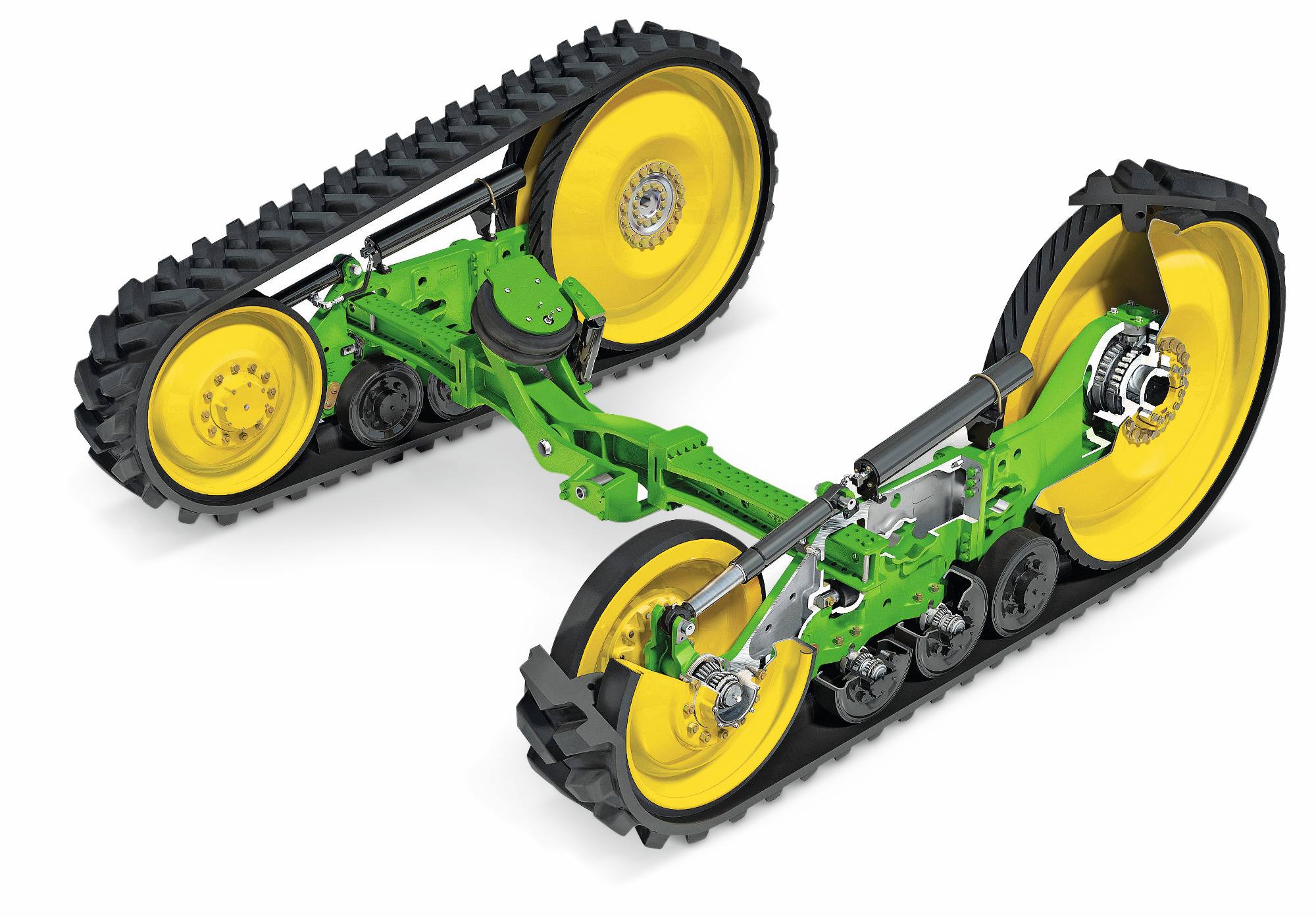 John Deere-traktorens bælteenheder med gummibælter, affjedringsarme og gule drivhjul, vist på en hvid studiebaggrund.