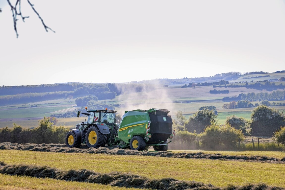 John Deere V462R trukket af en John Deere 6R 185-traktor, der presser høballer